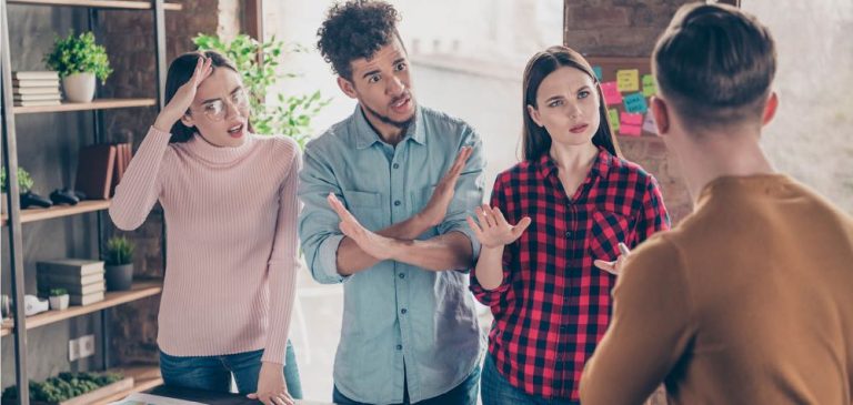 Un homme de dos qui est conflit avec 3 collègues
